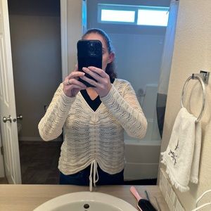 White knit top, can be long for a business look or tied into a crop top